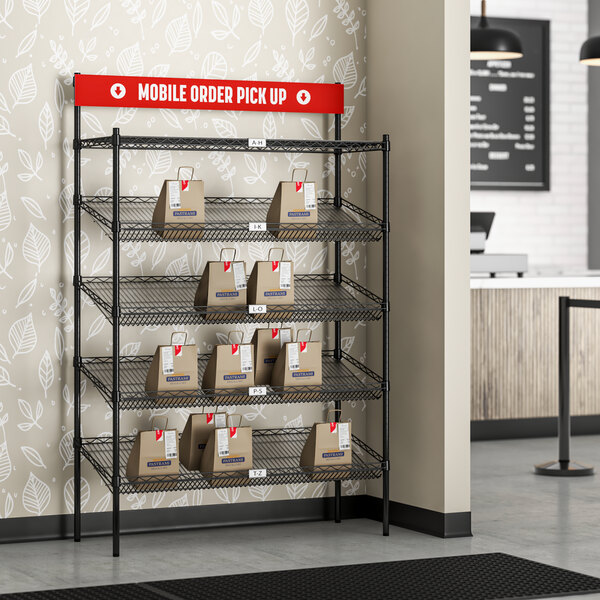 A black Regency epoxy shelving station with slanted baskets holding bags.
