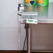 A stainless steel table with an Edlund Manual Can Opener on it.